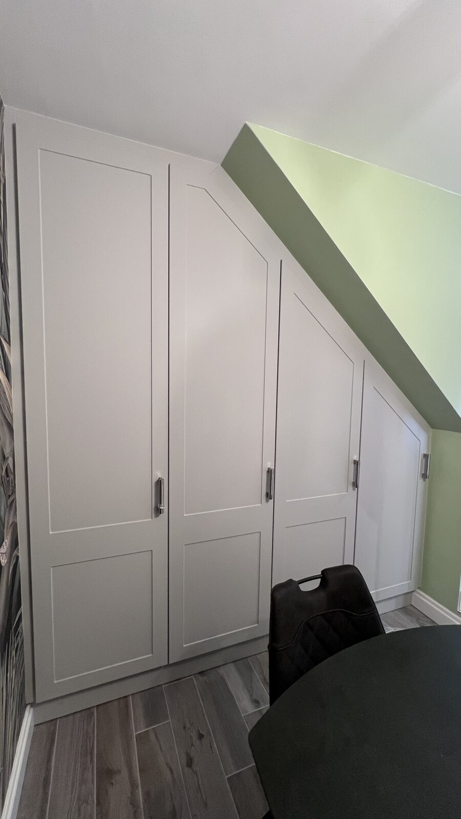 Fitted shaker wardrobes under sloped ceiling