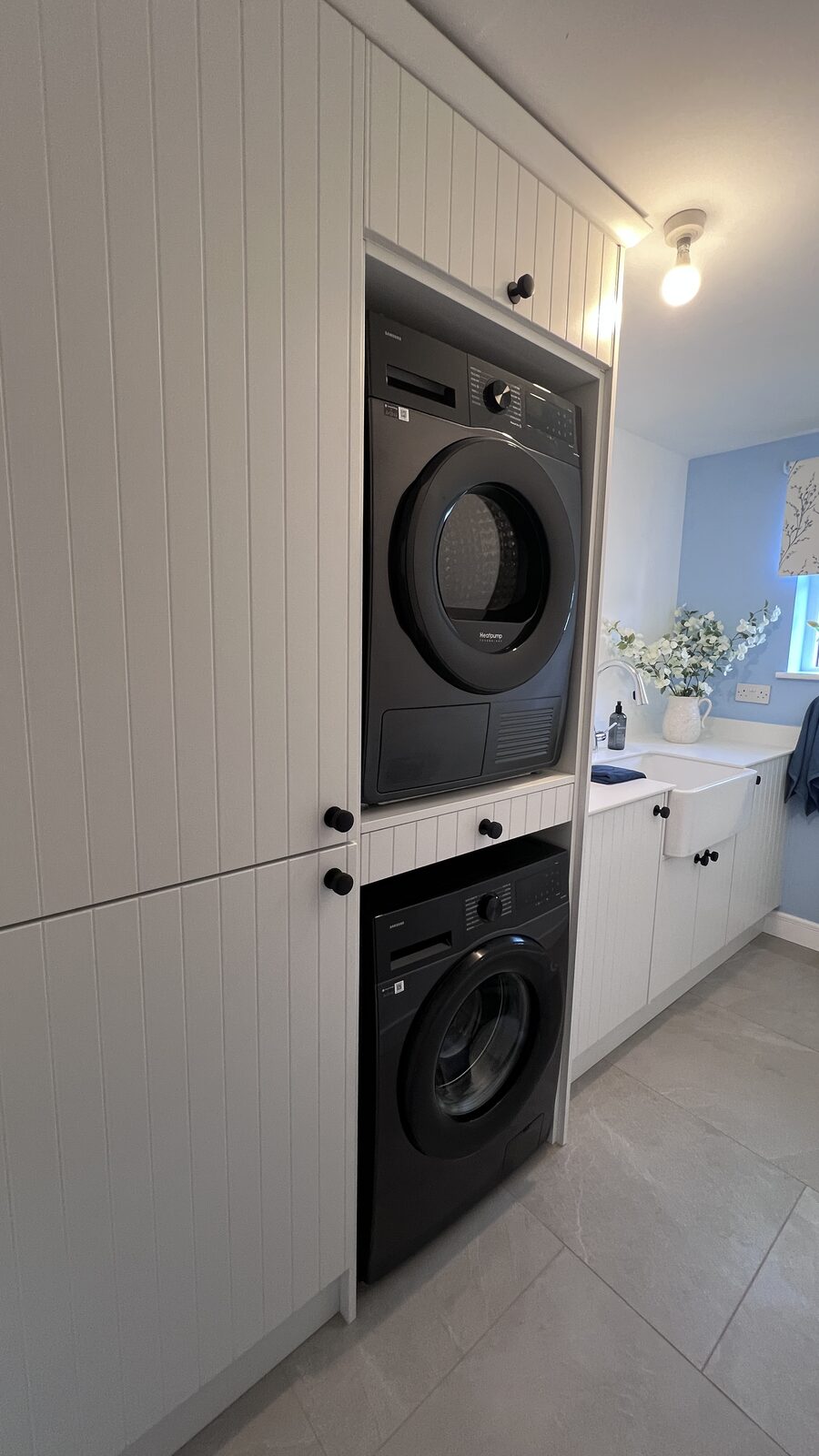 Bespoke utility room with stacked appliances